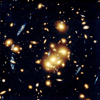 galaxy cluster warps light from distant blue spiral galaxy